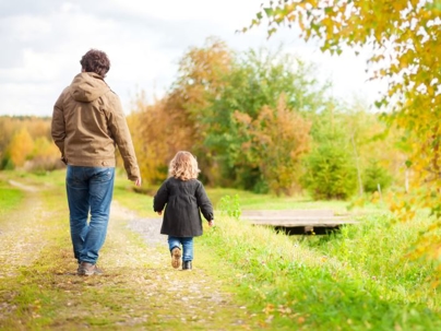 Dad and kid walk together