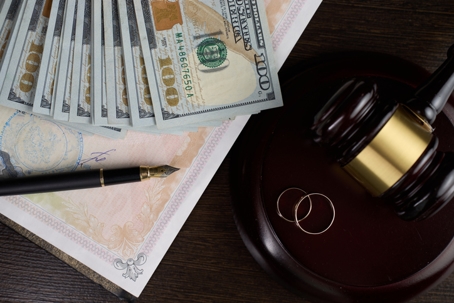 money, wedding rings, and a gavel